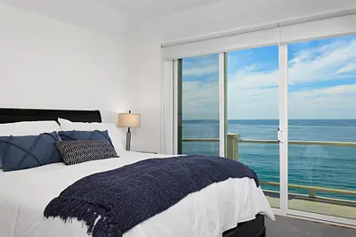a bedroom with a bed and a large window at Coastal Soul - ENC656N in Encinitas