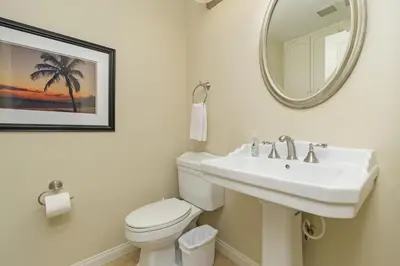 a bathroom with a sink and a toilet and a mirror at Sea'Esta by the Shore-DMBC852S in Solana Beach