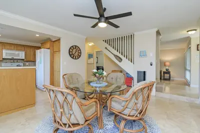 a kitchen and dining room with a table and chairs at Sea'Esta by the Shore-DMBC852S in Solana Beach