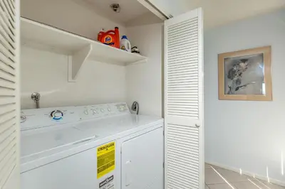 a white laundry room with a washer and dryer at Escape at Seascape - SUR112 in Solana Beach