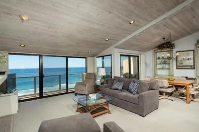 a living room with a view of the ocean at Escape at Seascape - SUR112 in Solana Beach