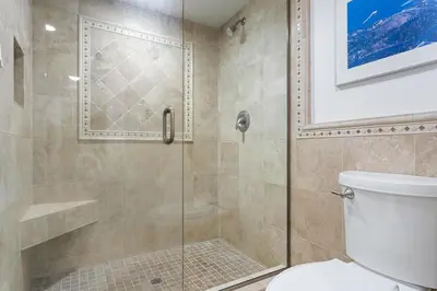 a bathroom with a glass shower with a toilet at Pacific Perch - SUR115S in Solana Beach