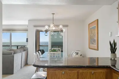 a kitchen and living room with a table and a couch at Pacific Perch - SUR115S in Solana Beach