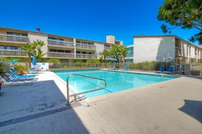 a swimming pool in front of a apartment building at Ocean Dreams - SBTC145 in Solana Beach
