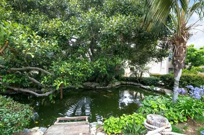 a pond in the middle of a garden at Cast-a-Waves - SUR29 in Solana Beach