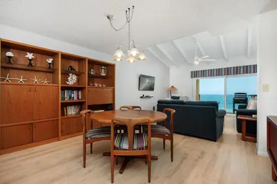 a living room with a table and a couch at Once Upon A Tide - SBTC312 in Solana Beach