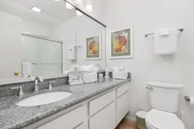 a bathroom with a sink and a toilet at Once Upon A Tide - SBTC312 in Solana Beach