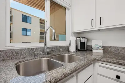 a kitchen counter with a sink and a window at Once Upon A Tide - SBTC312 in Solana Beach