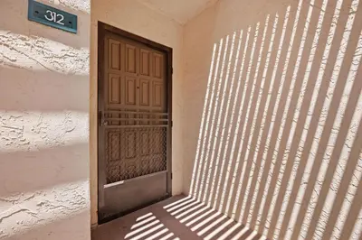 a door in a wall with a ray of sunlight at Once Upon A Tide - SBTC312 in Solana Beach