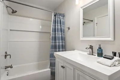 a white bathroom with a sink and a shower at Drift Away - DMBC884 in Solana Beach