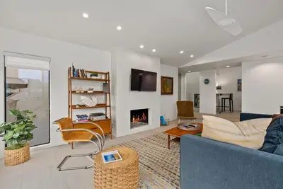 a living room with a couch and a fireplace at Hacienda Palms - SUR168 in Solana Beach