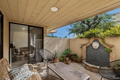 an outdoor patio with chairs and a fireplace at Hacienda Palms - SUR168 in Solana Beach