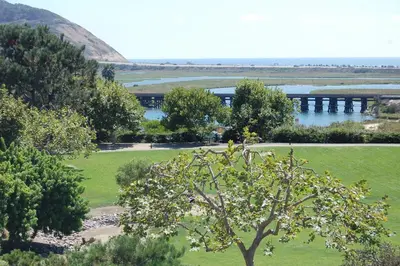 a park with a river and a bridge in the background at Torrey View Hideaway in San Diego