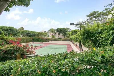 a tennis court in a garden with flowers at Salty Shores - SUR108 in Solana Beach