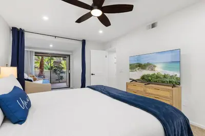 a bedroom with a bed and a ceiling fan at Mermaid's Lookout in San Diego