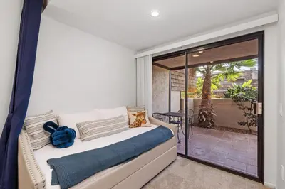 a bedroom with a bed and a sliding glass door at Mermaid's Lookout in San Diego