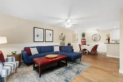 a living room with a blue couch and a table at Seaside Splash - SBTC169 in Solana Beach