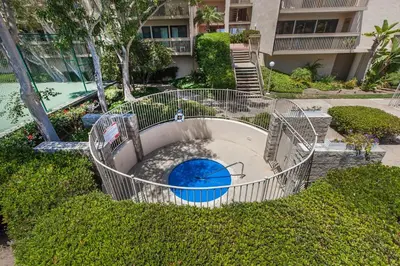 an empty pool with a playground in a yard at Seaside Splash - SBTC169 in Solana Beach