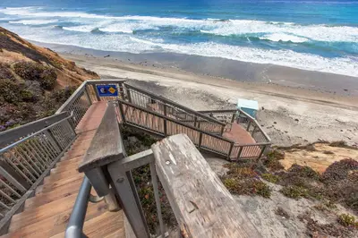 a wooden staircase leading to a beach with the ocean at Seaside Splash - SBTC169 in Solana Beach