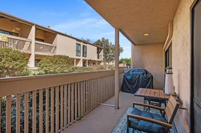 a balcony with a table and chairs on a building at Seaside Splash - SBTC169 in Solana Beach