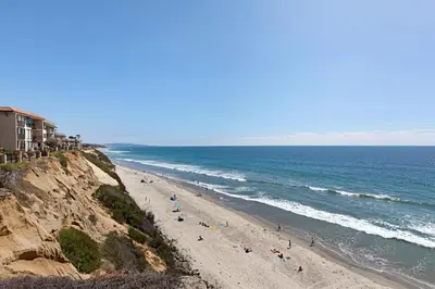 a group of people on a beach near the ocean at Whale Watch - DMST12 in Solana Beach