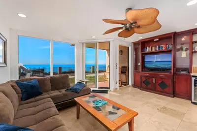 a living room with a couch and a ceiling fan at Whale Watch - DMST12 in Solana Beach