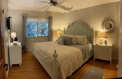 a bedroom with a bed and a ceiling fan at Avocado House in El Cajon