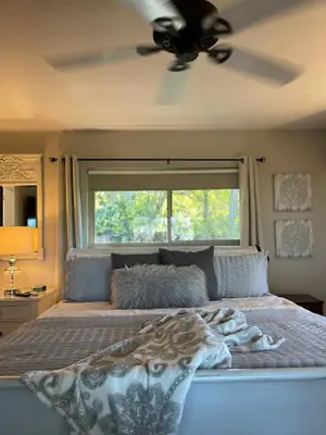 a bedroom with a bed with a ceiling fan at Avocado House in El Cajon