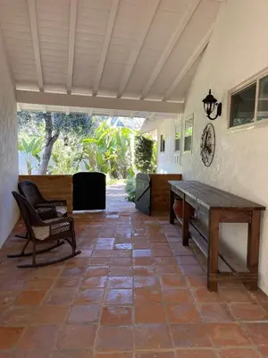 a patio with a wooden table and a bench at Avocado House in El Cajon