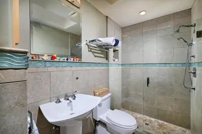 a bathroom with a toilet and a sink and a shower at Coastal Luxury with Panoramic Ocean View in Oceanside