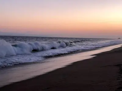 a beach with waves crashing on the shore at Balboa Peninsula Beach House Fireplace Bikes in Newport Beach