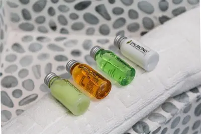 three glass bottles sitting on top of a bed at Balboa Peninsula Beach House Fireplace Bikes in Newport Beach