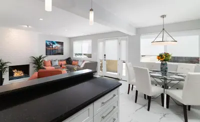 a kitchen and living room with a couch and a table at Balboa Peninsula Beach House Fireplace Bikes in Newport Beach
