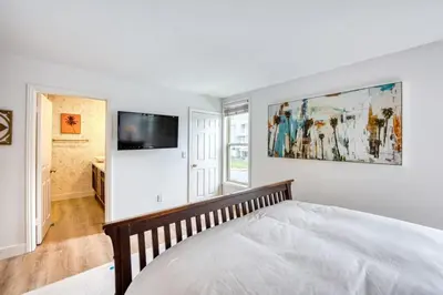 a bedroom with a bed and a tv on a wall at Ocean Harbor View Dana Point in Dana Point