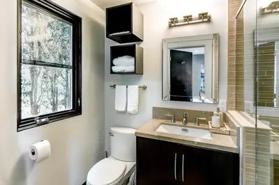 a bathroom with a toilet and a sink and a window at Hotel-Style Independent Suite in Ocean Beach in San Diego