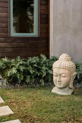 a statue of a head in the grass in front of a house at Hotel-Style Independent Suite in Ocean Beach in San Diego