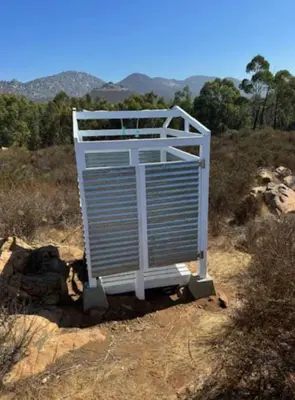 a white structure sitting on top of a field at Natures Nest in Poway