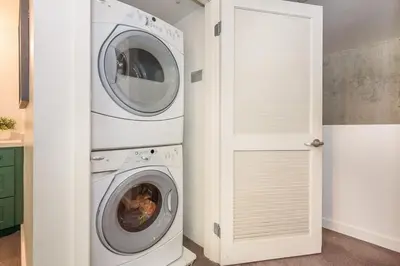 a washing machine and a washer and dryer in a room at King Size Luxury Loft Petco-Park-Downtown SD in San Diego