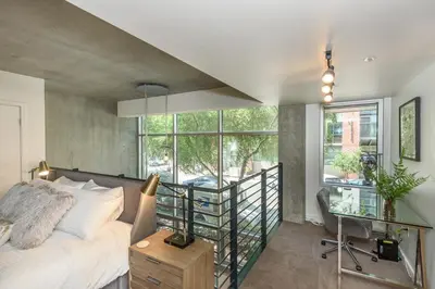 a bedroom with a bed and a desk and window at King Size Luxury Loft Petco-Park-Downtown SD in San Diego