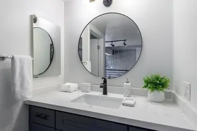 a white bathroom with a sink and a mirror at King Size Luxury Loft Petco-Park-Downtown SD in San Diego