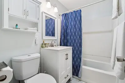 a bathroom with a toilet and a sink and a shower at O-Side Beach Bungalow with Jaccuzi Blocks to beach in Oceanside