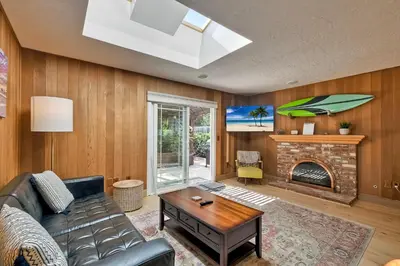 a living room with a couch and a fireplace at Hot Tub, Fire Pit, BBQ, Shuffleboard, Walk To Beach in Carlsbad