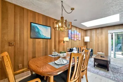 a dining room with a wooden table and chairs at Hot Tub, Fire Pit, BBQ, Shuffleboard, Walk To Beach in Carlsbad