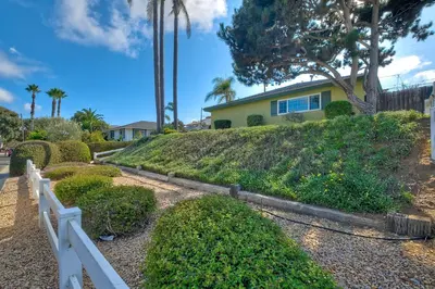 a white fence in front of a house at Hot Tub, Fire Pit, BBQ, Shuffleboard, Walk To Beach in Carlsbad