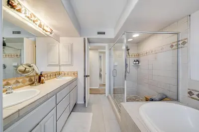 a bathroom with two sinks and a shower at Navigate Stays Front Row to Paradise in San Diego