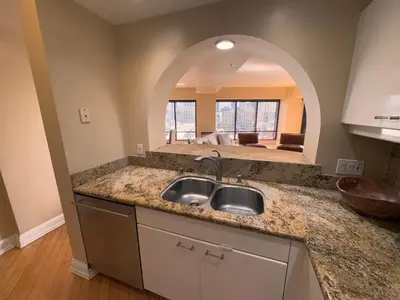a kitchen with a sink and an arched mirror at Luxurious and Spacious 2-Bedroom Condo Unit Downtown San Diego in the Heart of the Gaslamp Quarter - 14-Day Min in San Diego