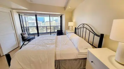 a bedroom with a large bed and a large window at Luxurious and Spacious 2-Bedroom Condo Unit Downtown San Diego in the Heart of the Gaslamp Quarter - 14-Day Min in San Diego
