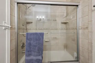 a shower with a blue towel in a bathroom at Ocean Song in San Diego