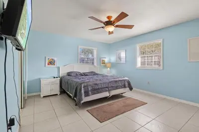 a bedroom with a bed and a ceiling fan at Ocean Song in San Diego