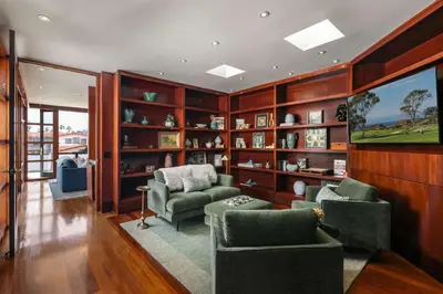 a living room with two chairs and a flat screen tv at Brand New Listing Elegant 7BR Masterpiece Walk to Beach Shops & Dining in San Diego